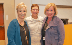 Carrie Byington, M.D., is flanked by TRI Director Laura James and Mary Aitken, M.D., who co-directs TRI's KL2 Scholars program.