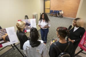 Jaky'ra Bolden discusses her poster with visitors. 