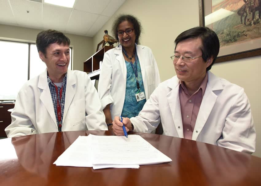 UAMS’ Craig Forrest, Ph.D., (left), credits his former mentors, Usha Ponnappan, Ph.D., and Xuming Zhang, Ph.D., D.V.M., with his early success.