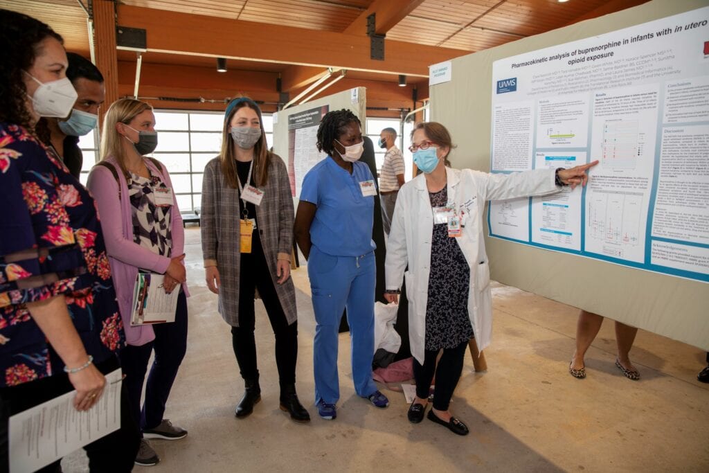 Clare Nesmith, M.D., presents her poster during TRI Research Day.