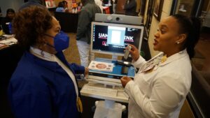 Alyssa Robinson, RN (right), representing the UAMS Institute for Digital Health & Innovation, demonstrated telehealth technologies during the expo.