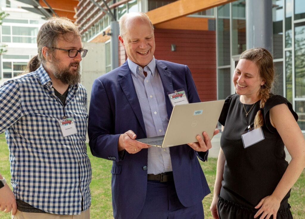 The Annual Report includes this photo of KL2 scholars Cody Ashby, Ph.D. (left), and Jennifer Rumpel, M.D., who say Mario Schootman, Ph.D. (center), has provided critical guidance to help advance their careers.