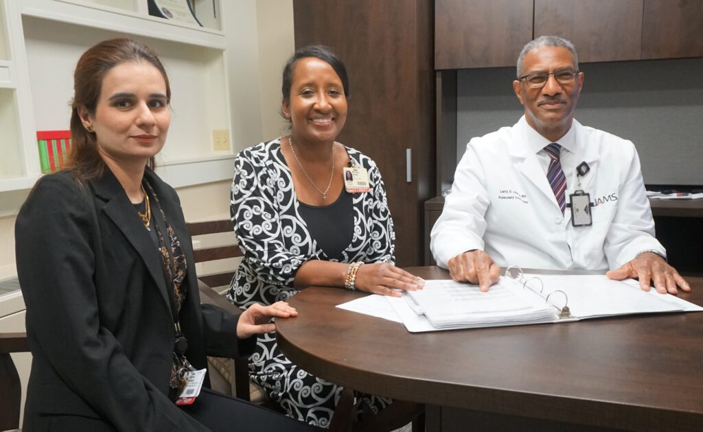 Larry Johnson, M.D. (right), is assisted on the study by TRI’s Faryal Jalbani, M.D., MSPH, regulatory affairs specialist II (left) and Monica Smith, B.A., CRS, TRI Regulatory Affairs manager.