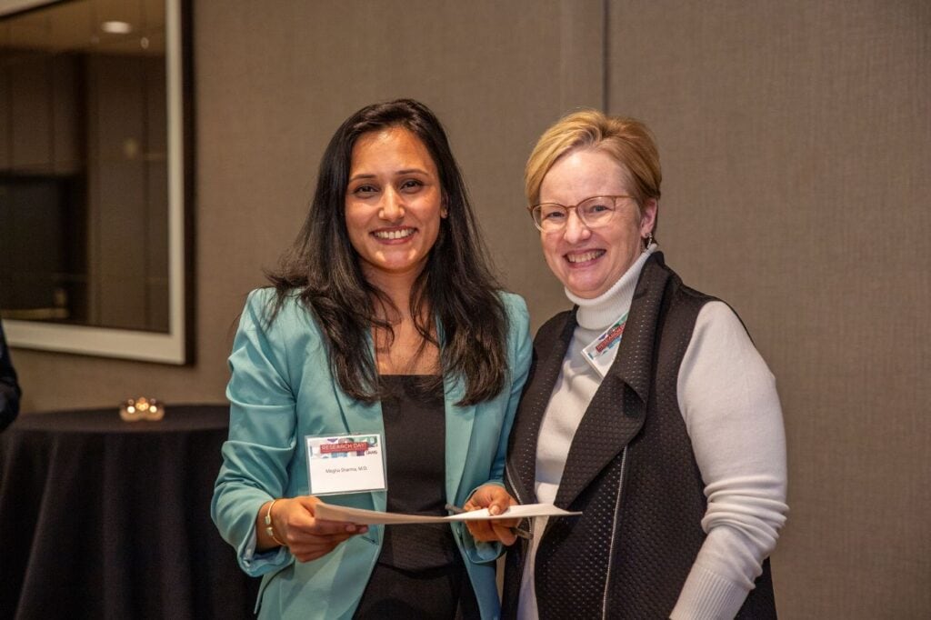 Megha Sharma, M.D., (left) was presented the People's Choice Award by TRI Director Laura James, M.D.