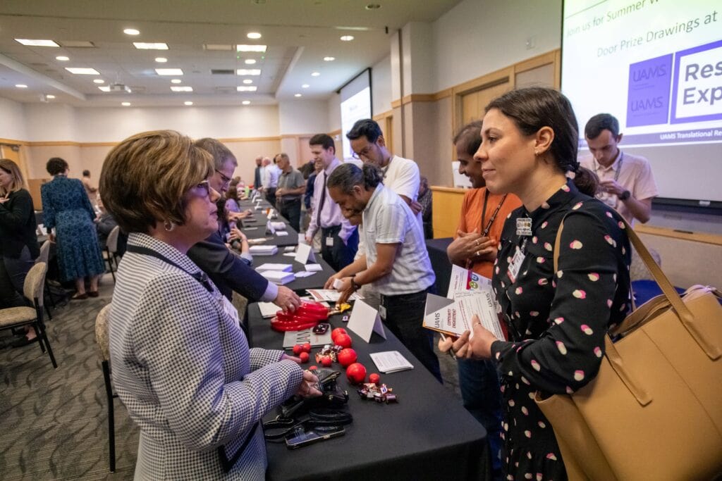 Kristen Muller, Ph.D. (right), speaks with Angie Brock, CRA, assistant director of Research Programs for the Office of Sponsored Programs Administrative Network (OSPAN).