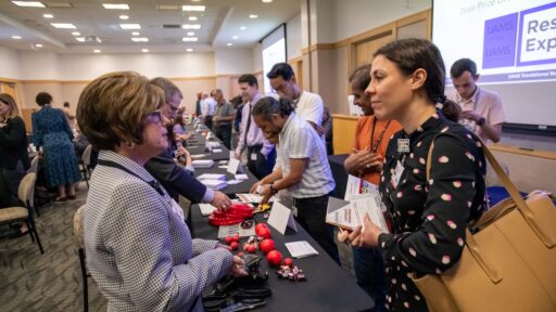 Kristen Muller, Ph.D. (right), speaks with Angie Brock, CRA, assistant director of the Office of Sponsored Programs Administrative Network (OSPAN).