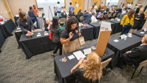 Jasmine Stewart, M.S., visits with Pam Kahler, program manager for TRI’s Health Science Innovation and Entrepreneurship Training Program for postdoctoral fellows. (Photo by Bryan Clifton)