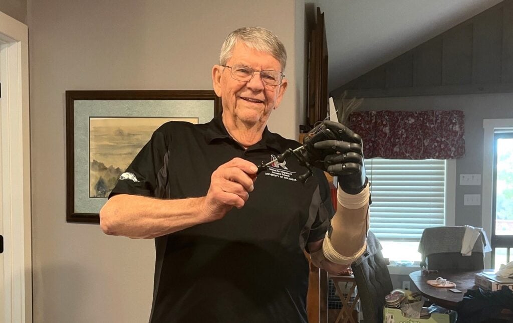 Dewey Hickey demonstrates how he used his prosthetic hand system to help repair his bait casting reel.