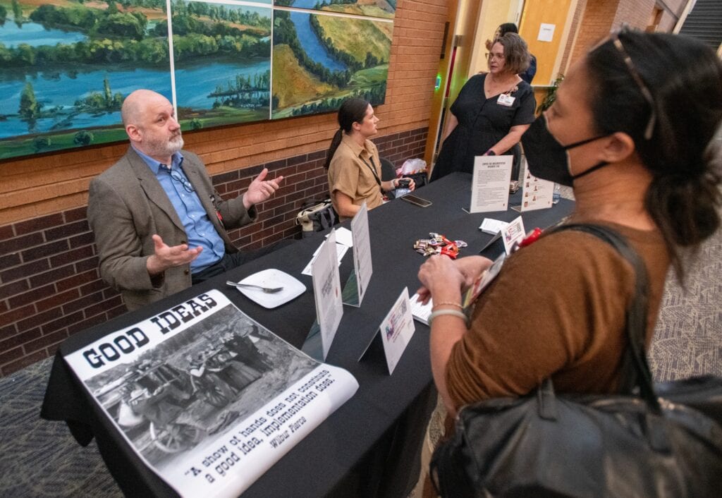 Geoffrey Curran, Ph.D., discusses implementation science opportunities with attendees of the 2024 TRI Research Expo. (Photo by Bryan Clifton)