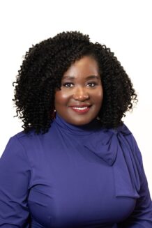 Krishna Ellington Krishna Ellington is a woman with black hair and wearing a purple top.