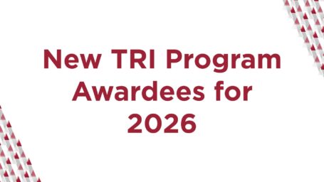 Graphic is white with red letters and reads, New TRI Program Awardees for 2026. Graphic includes pattern of series gray and red triangles in each corner.