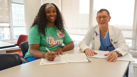 TRI’s Allyson Cheatham, B.S.N., RN, lead study coordinator, consults with Whit Hall, M.D., the study’s UAMS principal investigator.
